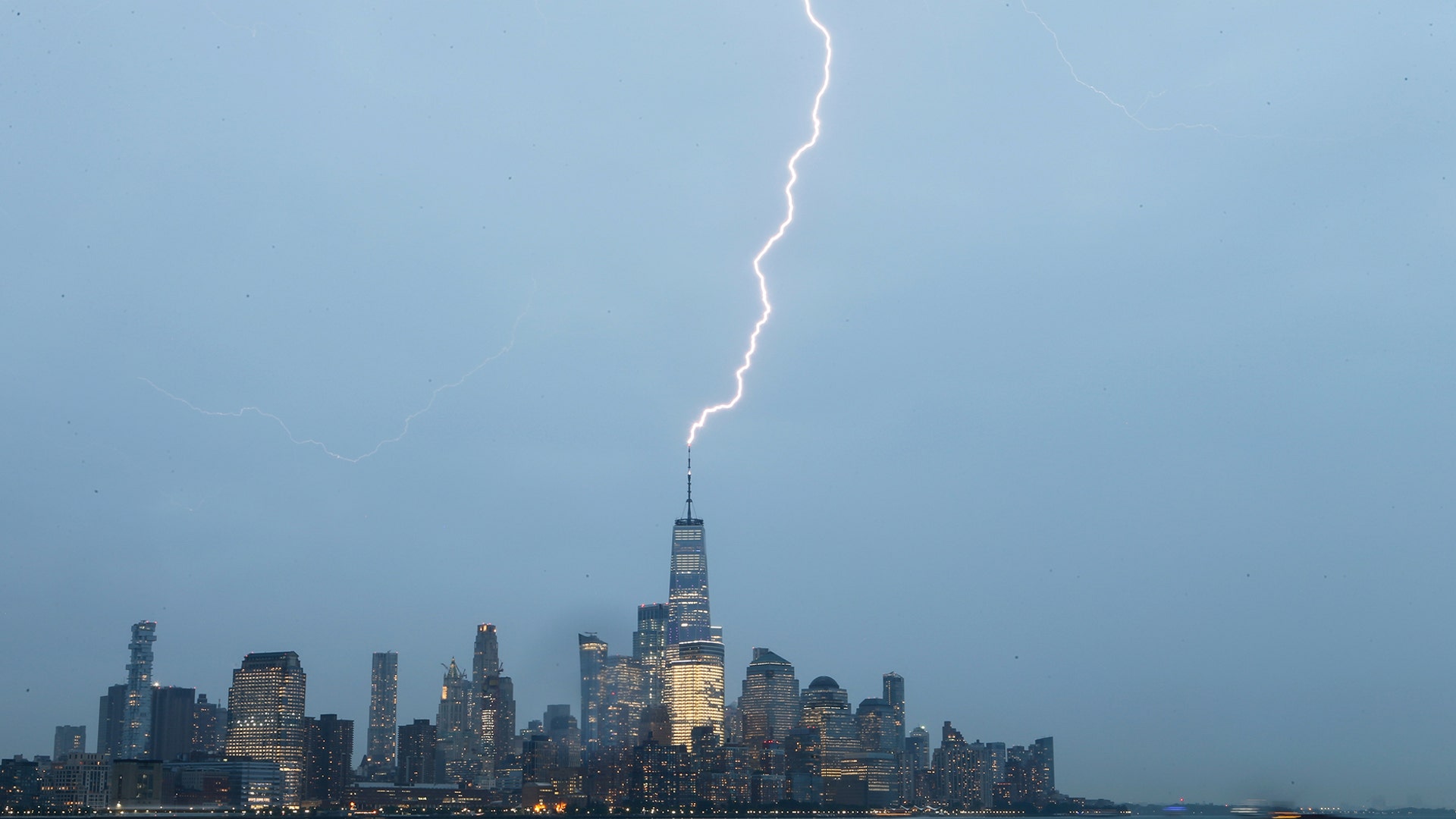 One World Trade Center is hit by a lightning bolt during a thunderstorm in New York City, Aug. 7, 2019.