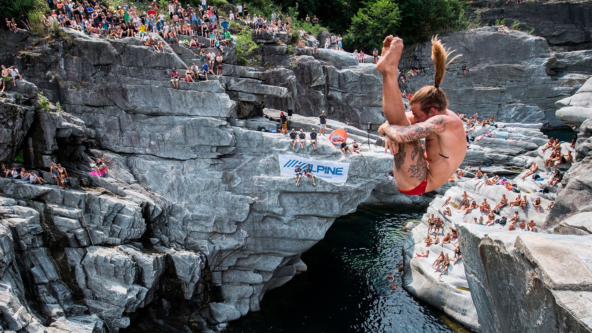 Matthias Appenzeller in action during the international cliff diving championships, in the Maggia valley in Ponte Brolla, Switzerland, July 27, 2019.