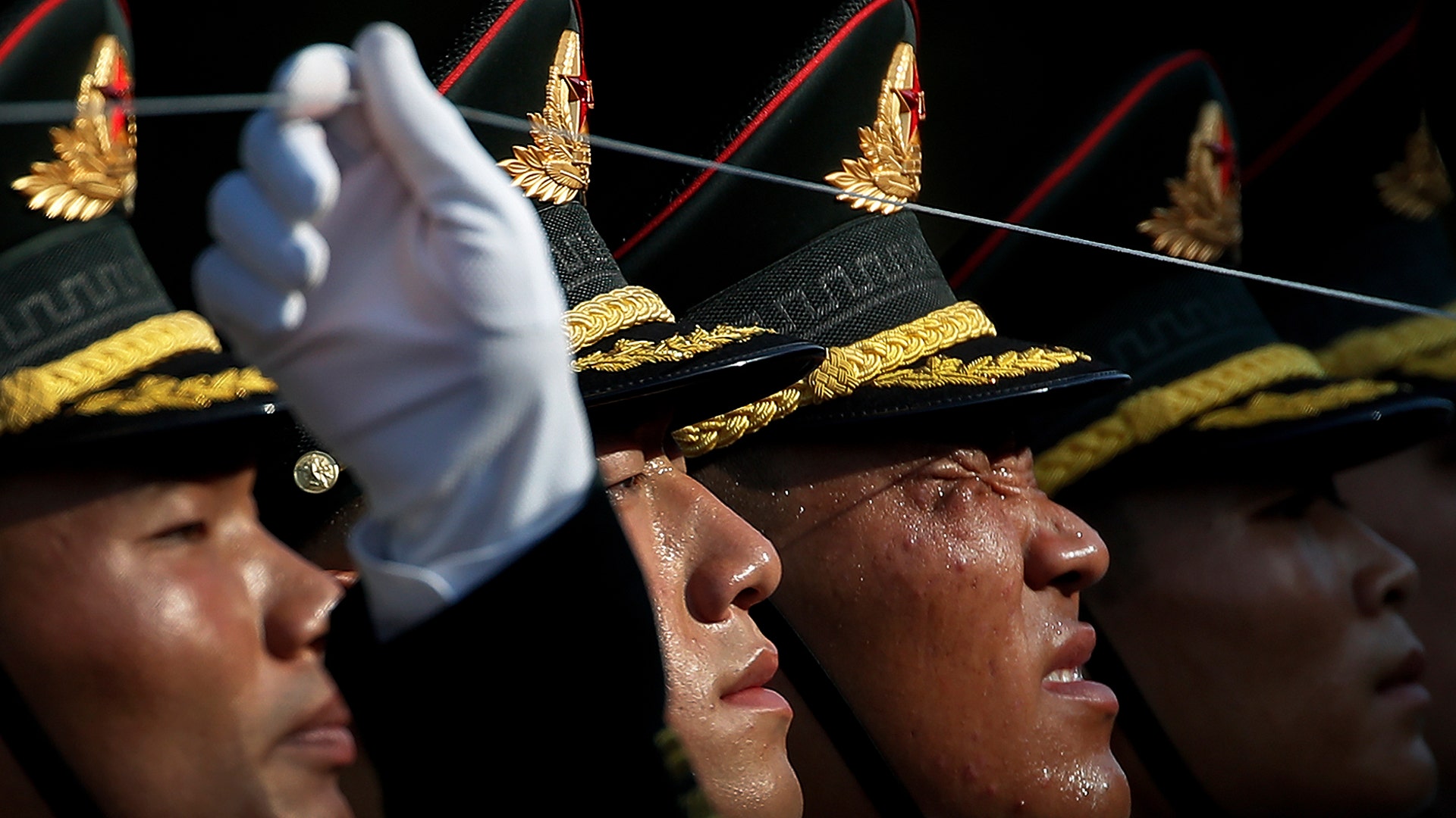 A member of an honor guard grimaces as he and his comrades prepare for a welcome ceremony for visiting Colombia's President Ivan Duque, at the Great Hall of the People in Beijing, July 31, 2019.