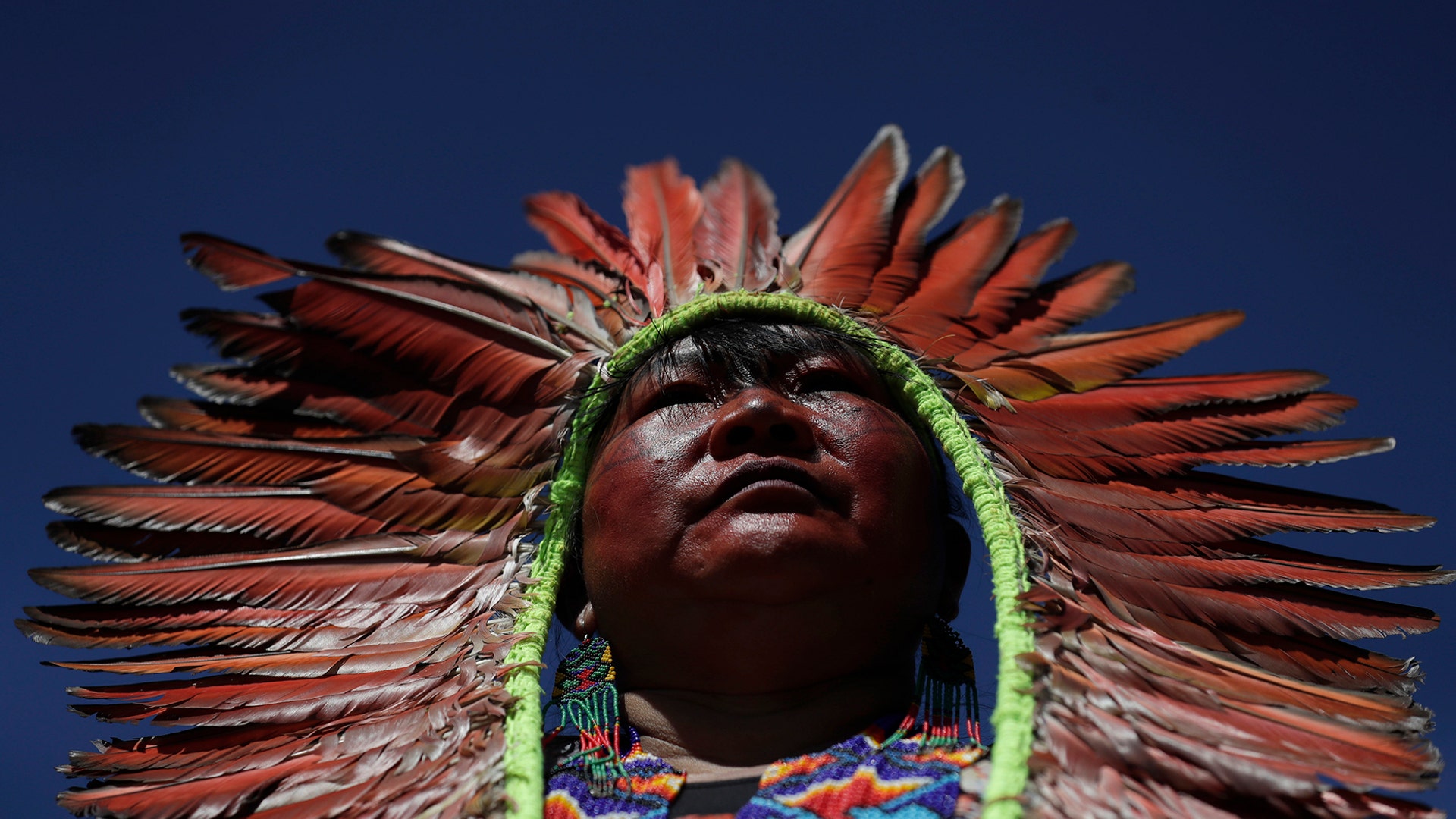 A female indigenous chief attends a march by indigenous women protesting the policies of Brazilian President Jair Bolsonaro in Brasilia, Brazil, Aug. 13, 2019.