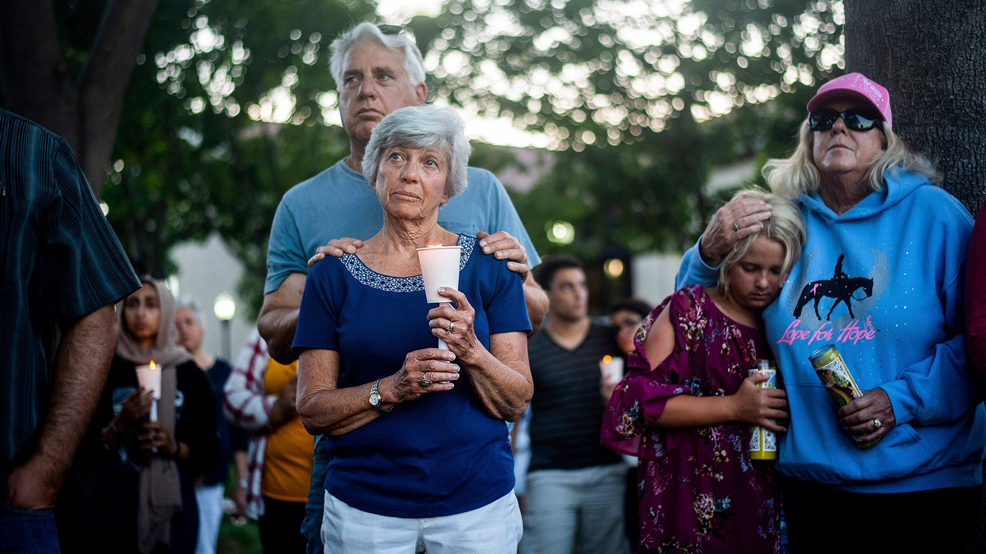 Susan Meyers and husband Michael Oshan listen to a hymn during a vigil for victims of a shooting that left three people dead at the Gilroy Garlic Festival, in Gilroy, California, July 29, 2019.