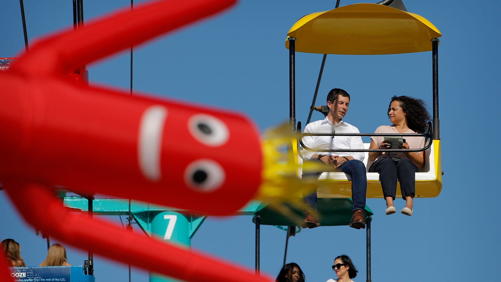 Democratic presidential candidate South Bend Mayor Pete Buttigieg rides the sky glider at the Iowa State Fair, in Des Moines, Iowa, Aug. 13, 2019.