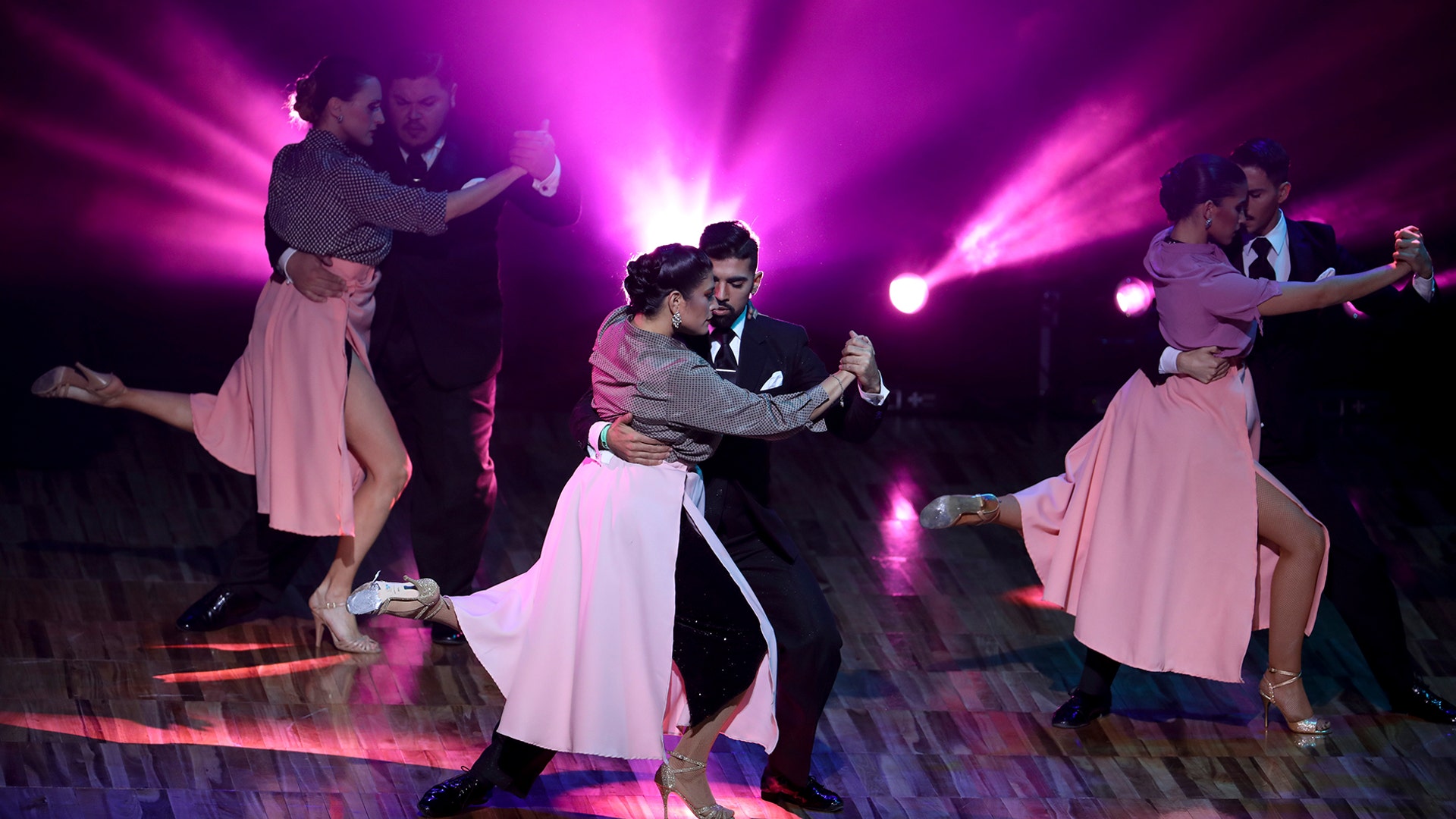 Couples dance during a show prior to the finals of the Salon category at the annual Tango Dance World Championship in Buenos Aires, Argentina, Aug. 20, 2019.