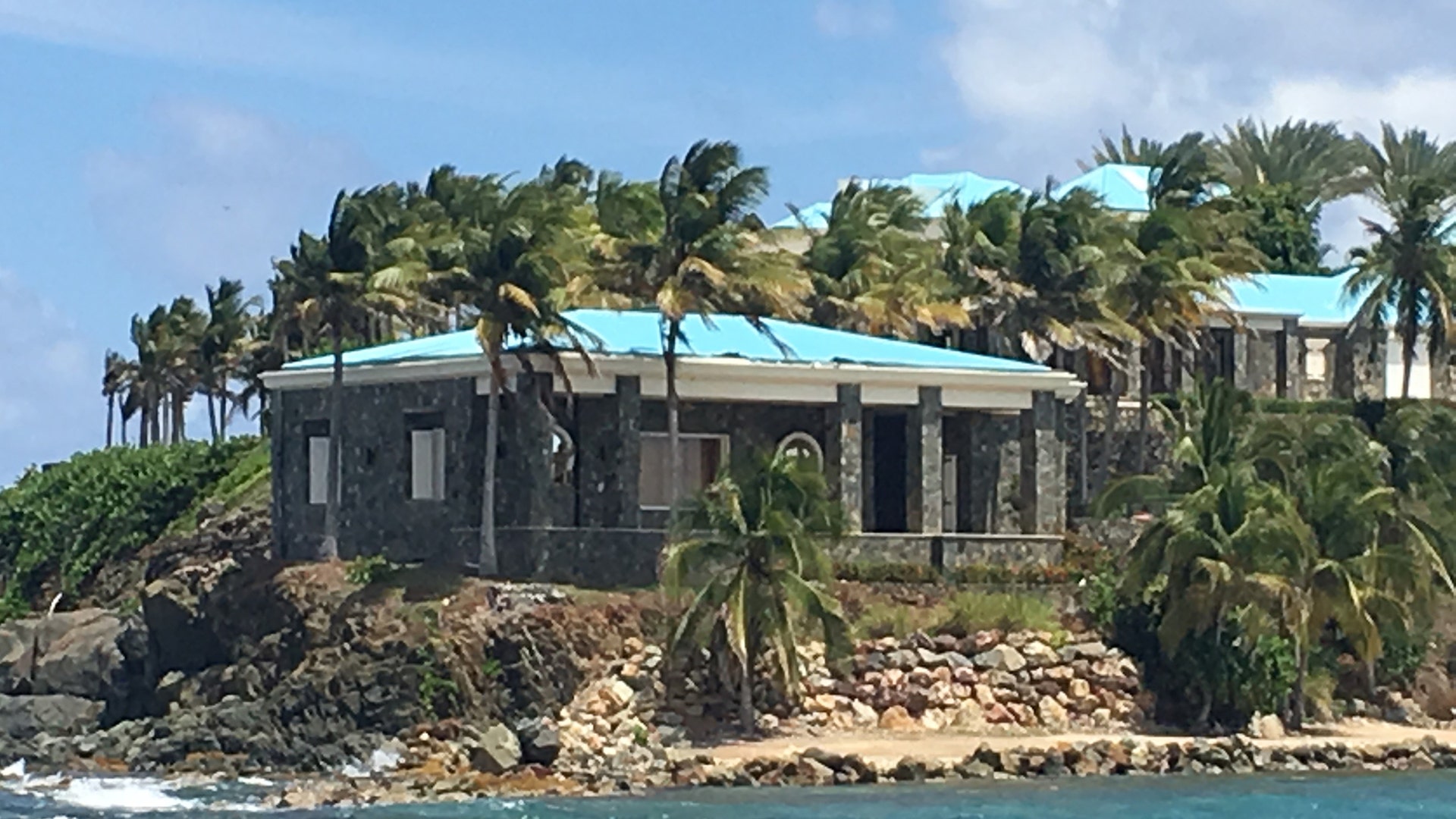 Palm trees around a building on Little St. James Island.