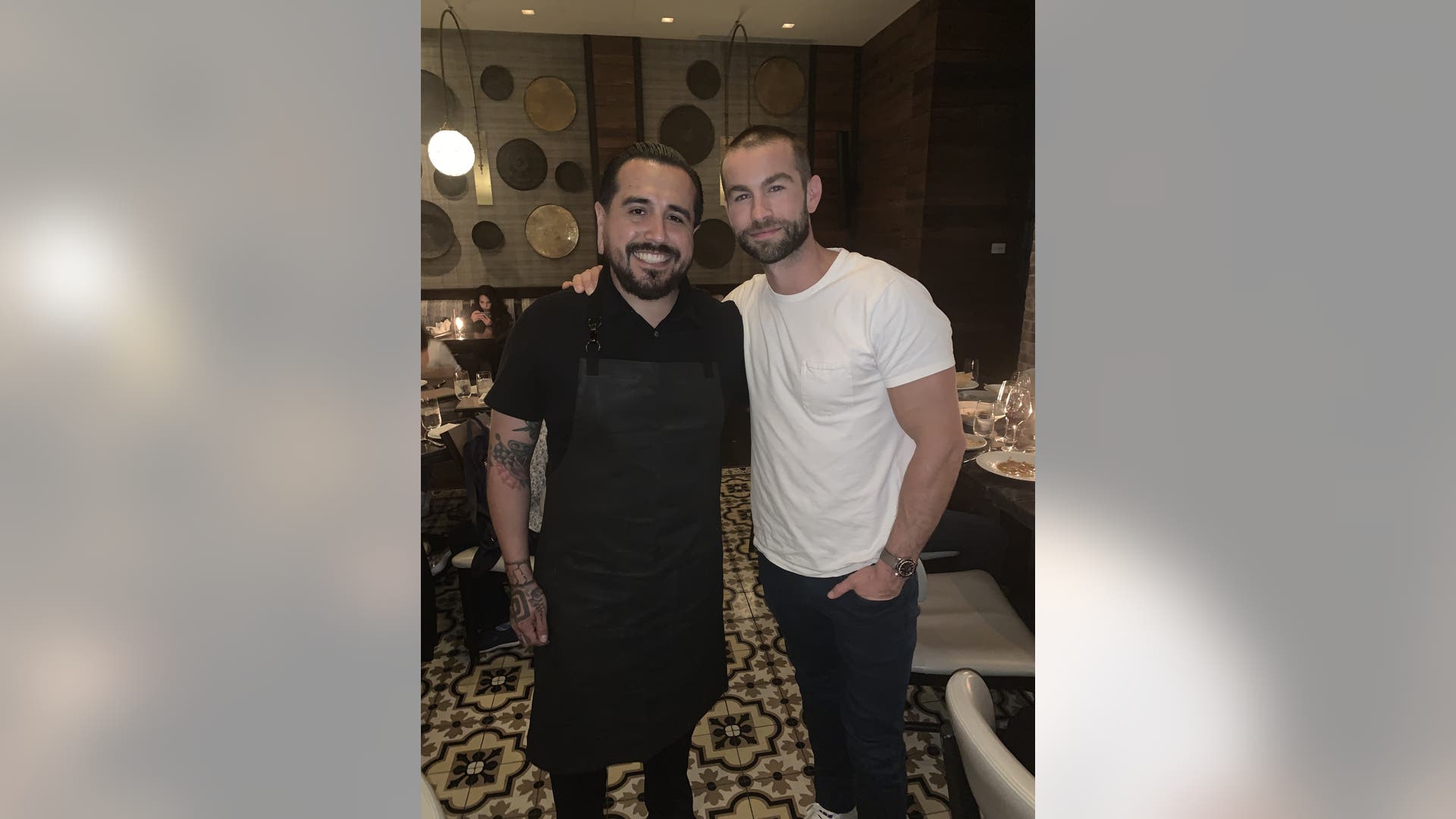 Chace Crawford is all smiles as he poses with James Beard Smart Catch Chef JoJo Ruiz at Lionfish Modern Coastal Cuisine inside Pendry San Diego during his 34th birthday dinner celebration to kick off Comic-Con on July 18, 2019 in San Diego, Calif. 