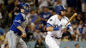 Los Angeles Dodgers' Cody Bellinger loses his pants sliding into third base