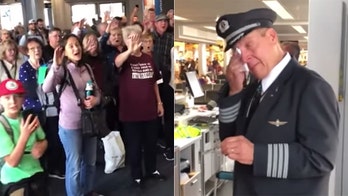 Pilot in tears after choir surprises him on his retirement flight: 'May God hold in you the palm of His hand'