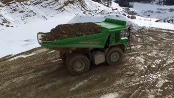 Giant electric dump truck runs on rocks and gravity