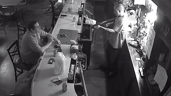 Video shows St. Louis bar patron calmly lighting cigarette during armed stick-up