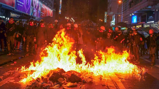 Hong Kong protesters defy ban to clash with police, hit with tear gas, water cannon