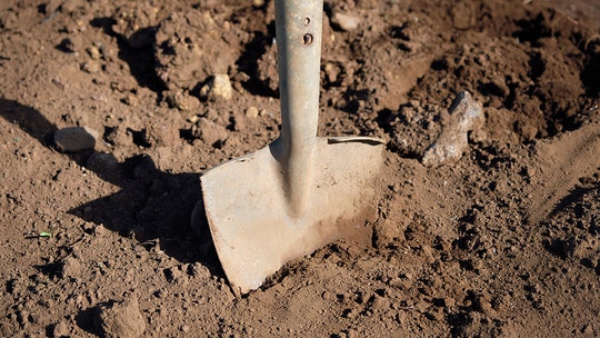 Kenyan officials exhume body to retrieve uniform