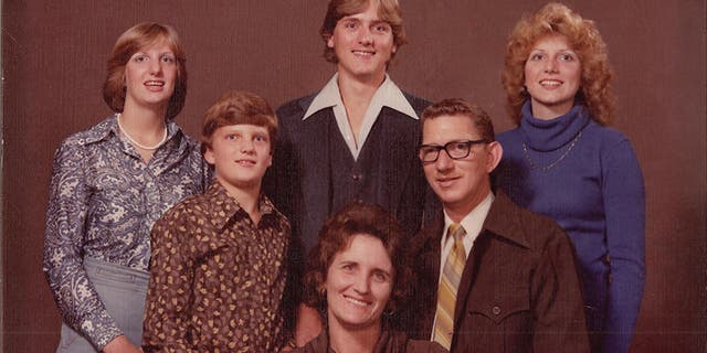 Delilah (wearing blue) and her family. — Courtesy of Delilah