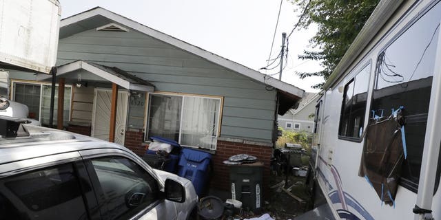 Vehicles are parked outside the home of Paige A. Thompson, who uses the online handle "erratic," Wednesday, July 31, 2019, in Seattle. (Associated Press)