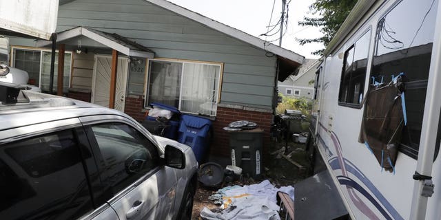 Vehicles are parked outside the home of Paige A. Thompson, who uses the online handle "erratic," Wednesday, July 31, 2019, in Seattle. (Associated Press)
