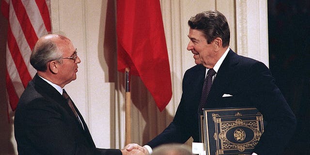 FILE - In this Dec. 8, 1987, file photo, President Ronald Reagan, right, shakes hands with Soviet leader Mikhail Gorbachev after the two leaders signed the Intermediate Range Nuclear Forces Treaty to eliminate intermediate-range missiles during a ceremony in the White House East Room in Washington. The landmark arms control treaty that Reagan and Gorbachev signed three decades ago is dead. The U.S. and Russia both walked away from the deal on Friday, Aug. 2, 2019.