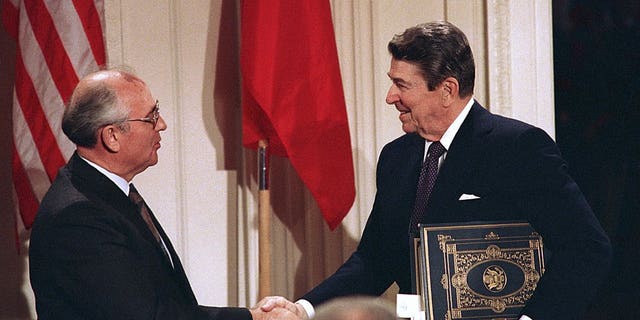 President Ronald Reagan, right, shakes hands with Soviet leader Mikhail Gorbachev after the two leaders signed the Intermediate-Range Nuclear Forces (INF) Treaty to eliminate intermediate-range missiles during a ceremony in the White House East Room in Washington, Dec. 8, 1987. (Associated Press)