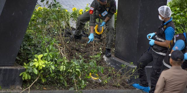 Thai investigators examine a site of an explosion in Bangkok, Thailand, Friday, Aug 2, 2019. Thai Prime Minister Prayuth Chan-o-cha on Friday ordered an investigation into several small bombings in Bangkok that took place as Thailand was hosting a high-level meeting attended by U.S. Secretary of State Mike Pompeo and his counterparts from China and several Asia-Pacific countries.