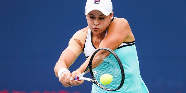 Ashleigh Barty, of Australia, returns a shot to Sofia Kenin, of the United States, during the Rogers Cup women’s tennis tournament Tuesday, Aug. 6, 2019, in Toronto. (Mark Blinch/The Canadian Press via AP)
