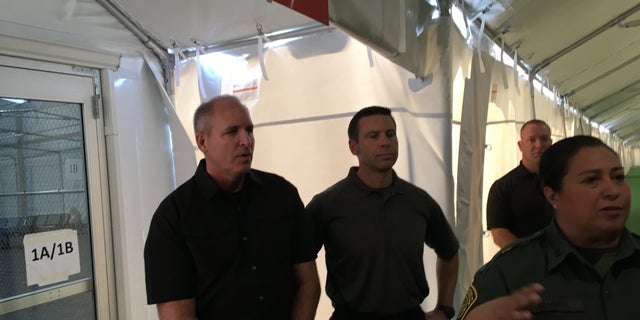 Touring a new migrant holding facility at the Tornillo Port of Entry in Texas are, from left, Mark Morgan, acting commissioner of U.S. Customs and Border Protection, and Kevin McAleenan, acting secretary of Homeland Security. (Charlie Lapastora/Fox News)