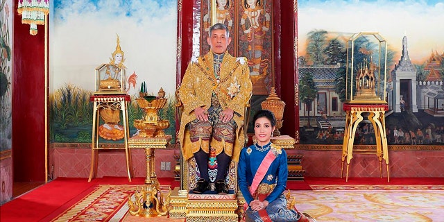 This undated photo posted Monday, Aug. 26, 2019 on the Thailand Royal Office website shows King Maha Vajiralongkorn with Major General Sineenat Wongvajirapakdi, the former royal noble consort. (Thailand Royal Office via AP)