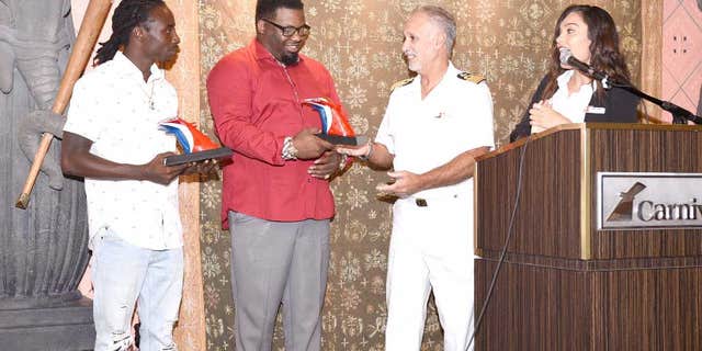 Captain Candeloro Donato handed the awards to Donovan and Hamilton, who were working with an entertainment group on the St. Thomas dock when they witnessed the girl go into the water.