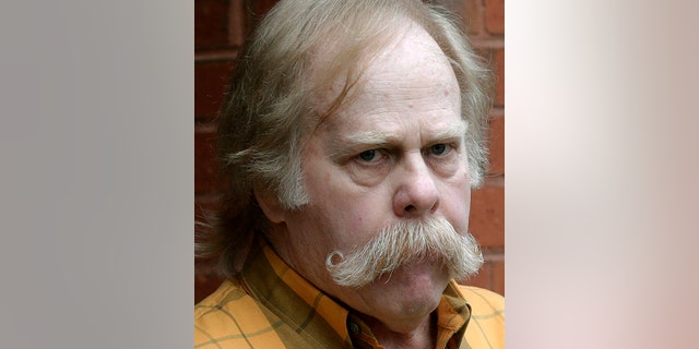 FILE -- In this June 10, 2013 file photo, University of Alabama fan Harvey Updyke departs the Lee County Justice Center in Opelika, Ala., after pleading guilty earlier to poisoning landmark oak trees at Auburn University. Updyke, a retired Texas state trooper, was ordered to pay about $800,000 in restitution, and he is due in court on Oct. 30, 2019, to explain why the money isn't being paid. (AP Photo/Dave Martin, File)