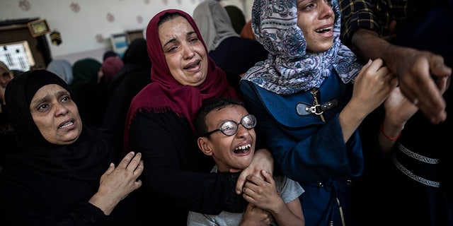 Relatives mourning the death of Palestinian Hamas militant Mohammad Abu Namous during his Gaza funeral Sunday.