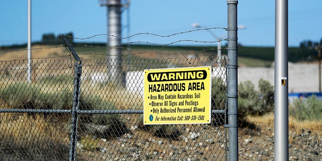 A sign in the Hanford Nuclear Reserve warning of potential hazards in the soil along the Columbia River near Richland, Washington. (AP Photo / Elaine Thompson)