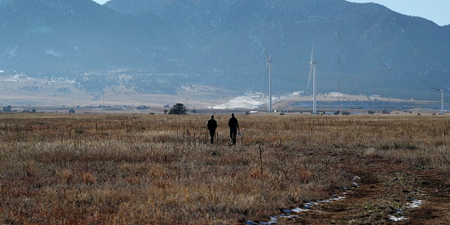 FILE - In this Sunday, Nov. 18, 2018 file photo, hikers head down a trail in the Rocky Flats National Wildlife Refuge in Broomfield, Colo. The former nuclear weapons plant northwest of Denver opened to hikers and cyclists in September 2018, but some activists question whether it’s safe. (AP Photo/David Zalubowski)