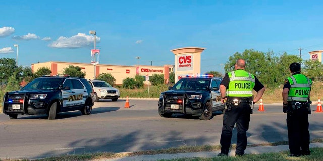 San Antonio Police cordoned off the neighborhood where a suspect killed three people Monday. (Valeria Olivares/The San Antonio Express-News via AP)