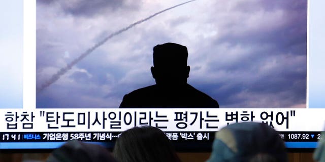 People watching a TV showing an image of North Korea's a multiple rocket launch during a news program at the Seoul Railway Station in South Korea on Aug. 1.