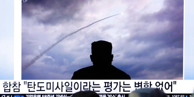 People watching a TV showing an image of North Korea's a multiple rocket launch during a news program at the Seoul Railway Station in South Korea on Aug. 1.