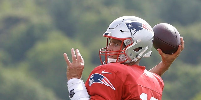 New England Patriots quarterback Tom Brady winds up to pass during an Aug. 1 NFL football training camp practice in Foxborough, Mass. (AP Photo/Steven Senne)