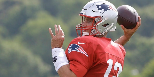 New England Patriots quarterback Tom Brady winds up to pass during an Aug. 1 NFL football training camp practice in Foxborough, Mass. (AP Photo/Steven Senne)