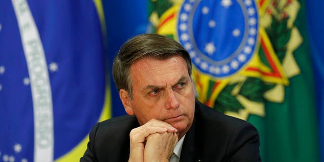 Brazil's President Jair Bolsonaro, seen here, "doesn't deserve" any respect, trust or dignity, the author said.