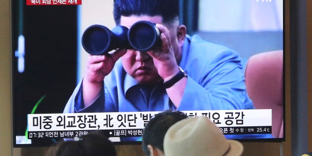 People watch a TV showing a file footage of North Korean leader Kim Jong Un during a news program at the Seoul Railway Station in Seoul, South Korea, Friday, Aug. 2, 2019. The sign reads "North Korea launches frequently." (Associated Press)