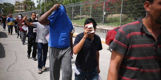 Migrants return to Mexico from the Brownsville, Texas Port of Entry last week. (AP Photo/Emilio Espejel, File)