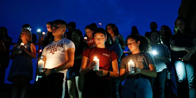 From left, Samuel Lerma, Arzetta Hodges and Desiree Quintanar attend a vigil for victims of the deadly shooting that occurred earlier in the day at a shopping center Saturday, Aug. 3, 2019, in El Paso, Texas. (Associated Press)