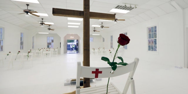 FILE - In this Nov. 12, 2017, file photo, a rose rests on a chair during a memorial for the victims of the shooting at Sutherland Springs First Baptist Church at the church in Sutherland Springs, Texas. At the church where more than two dozen people were killed by a gunman in 2017, Pastor Frank Pomeroy sought to boost his followers' resolve with upbeat remarks at Sunday's service. He urged them not to live "in a spirit of fear." (AP Photo/Eric Gay, File)
