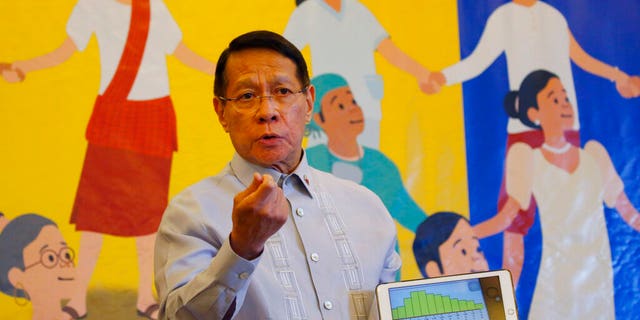 In this April 30, 2019 file photo, Philippine Health Secretary Dr. Francisco Duque III displays a graph showing the decline of the measles outbreak in the country during a press conference during World Immunization Week 2019 in Manila, Philippines. The Philippines' Department of Health has declared the country's massive outbreak of dengue to be a national epidemic on Tuesday Aug. 6, 2019.