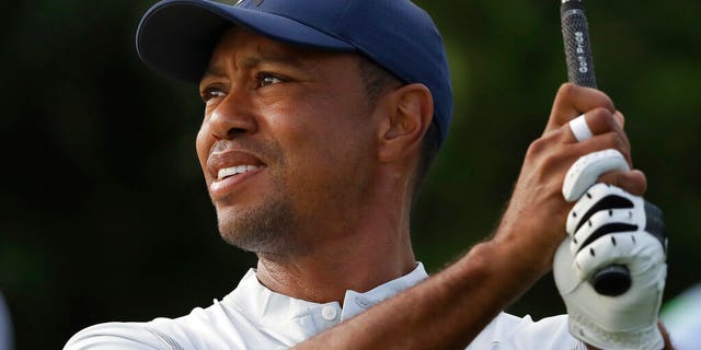 Tiger Woods tees off on the 12th hole at the Northern Trust golf tournament at Liberty National Golf Course, Thursday, Aug. 8, 2019, in Jersey City, N.J.