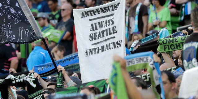 A sign that reads "Anti-Facist Always Seattle Anti-Racist" is displayed in the supporters section during an MLS soccer match between the Seattle Sounders and the Portland Timbers in Seattle, July 21, 2019. (Associated Press)