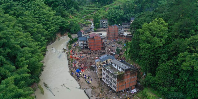 Rescuers search for victims of a landslide triggered by Typhoon Lekima in Yongjia county in eastern China's Zhejiang province on Saturday, Aug. 10, 2019.