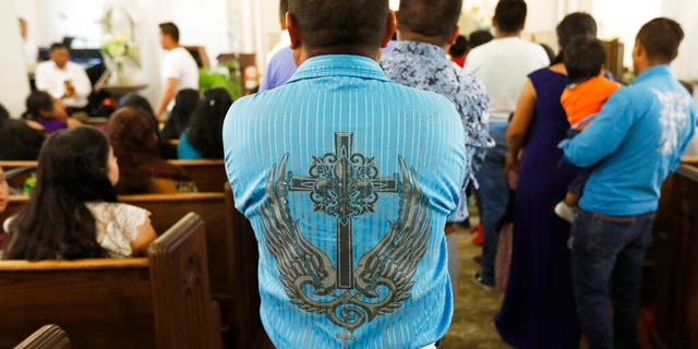 A man standing in line to receive communion during a Spanish mass at Sacred Heart Catholic Church in Canton, Miss.