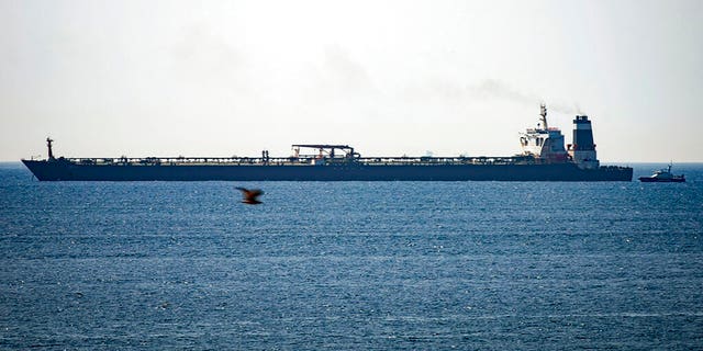 In this file photo dated Thursday, July 4, 2019, Grace 1 super tanker is anchored near a Royal Marine patrol vessel off the coast of the British territory of Gibraltar. 