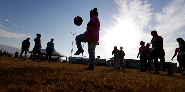 Immigrants play football at US Government's Migrant Children's Detention Center in Carrizo Springs, Texas on July 9, 2019. (Associated Press)