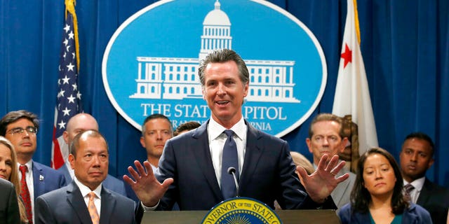 California Gov. Gavin Newsom, center, during a news conference in Sacramento, Calif., Friday, Aug. 16, 2019.