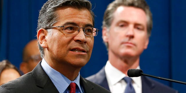 California Attorney General Xavier Becerra, left, accompanied by Gov. Gavin Newsom, during a news conference in Sacramento, Calif., Friday, Aug. 16, 2019.