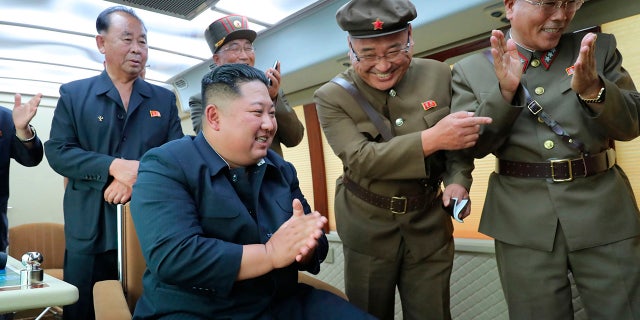 In this Friday, Aug. 16, 2019, photo provided Saturday, Aug. 17, by the North Korean government, North Korean leader Kim Jong Un, center, watches the test firing of an unspecified new weapon at an undisclosed location in North Korea. North Korea on Saturday said leader Kim supervised another test-firing of an unspecified new weapon that extended a streak of weapons demonstrations seen as an attempt to pressure Washington and Seoul over slow nuclear negotiations and their joint military exercises. The content of this image is as provided and cannot be independently verified. Korean language watermark on image as provided by source reads: "KCNA" which is the abbreviation for Korean Central News Agency. (Korean Central News Agency/Korea News Service via AP)