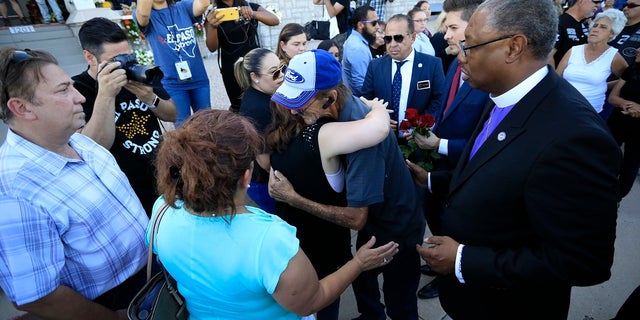 Supporters greeting Antonio Basco, center right, outside his partner's funeral. (AP Photo/Jorge Salgado)